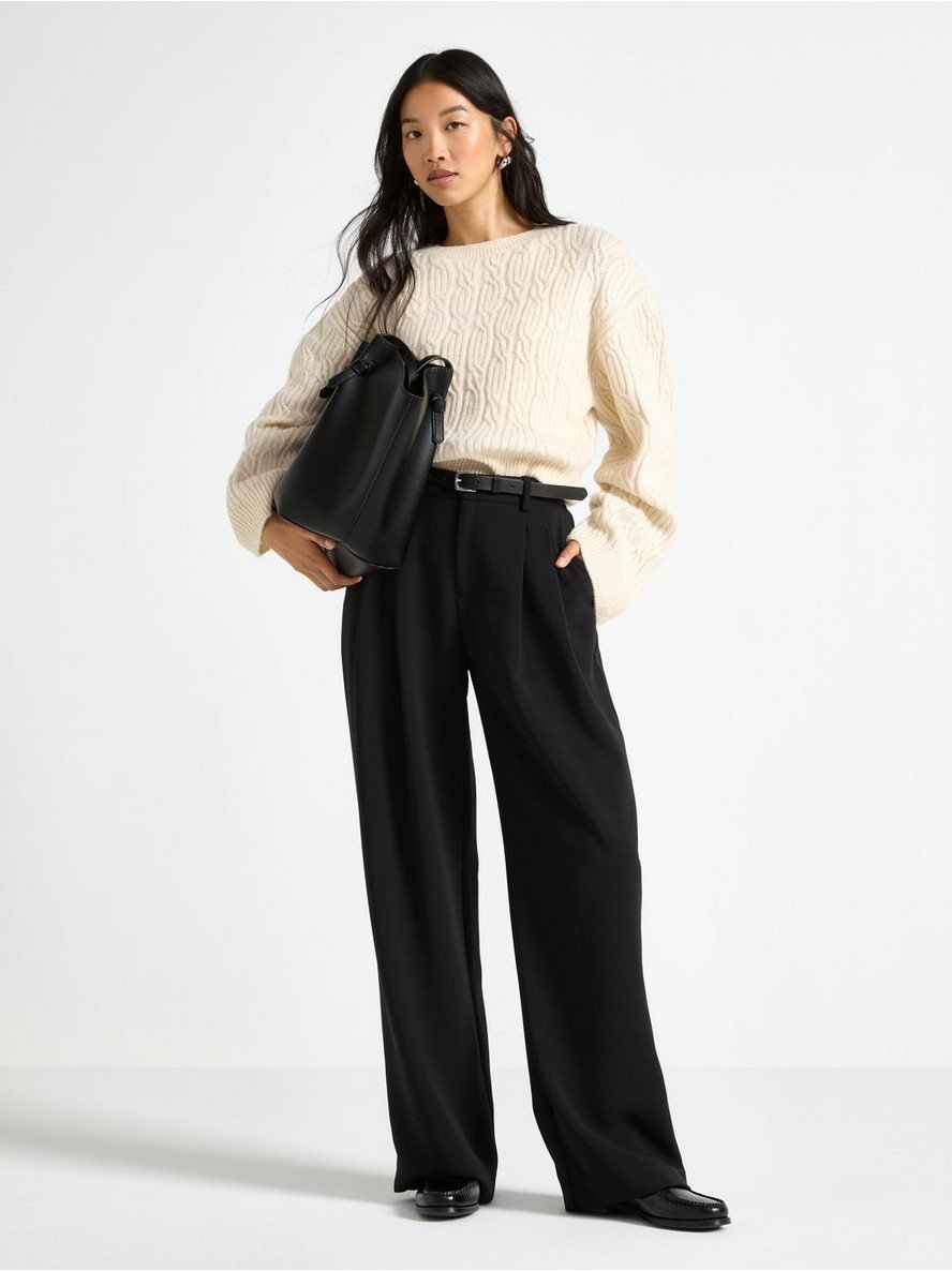 Cotiful pleated wide leg trousers in black, worn with a cream knit